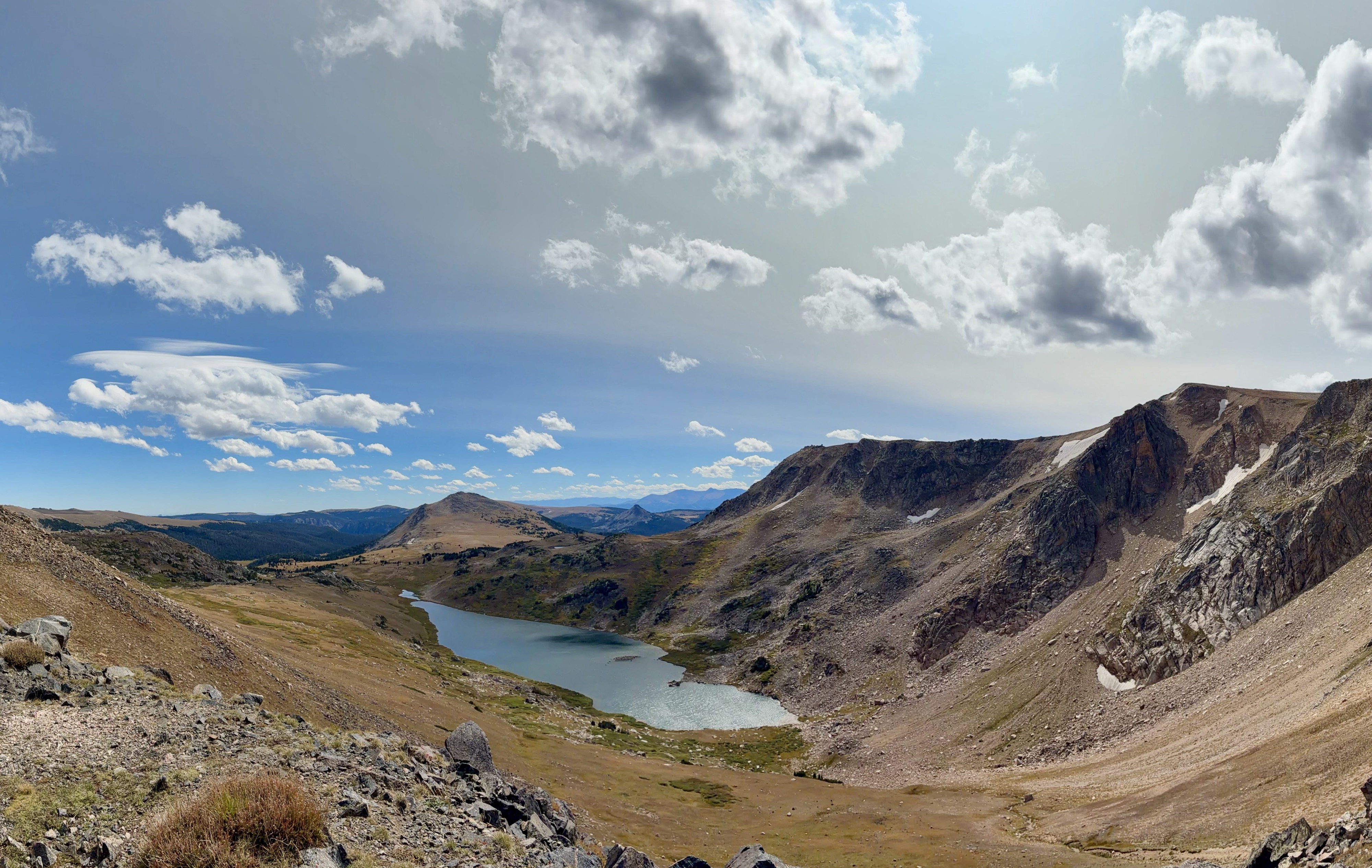 Beartooth Pass scenic view with clouds, lake and mountain.